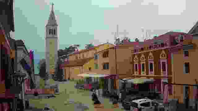 Square with tower on Velika street in Novigrad city, Croatia.